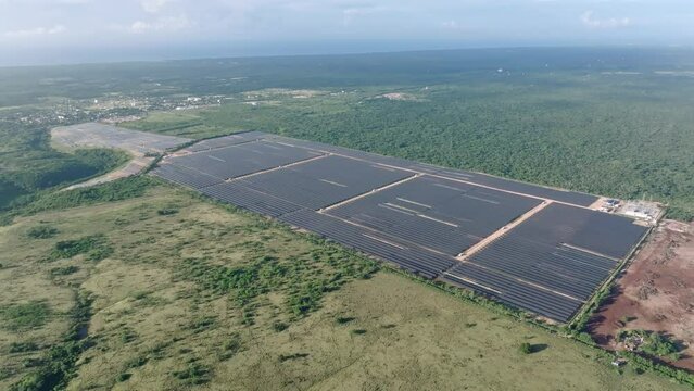 Aerial View Of Solar Panels Producing Energy In Green Field, Parque Solar Fotovoltaico Cumayasa In Dominican Republic - Drone Shot