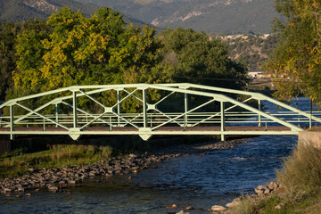 Fototapeta premium Iron bridge over the Arkansas River in Howard Colorado United States