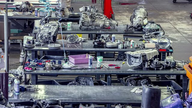 Mechanic's garage with automobile engines being repaired and rebuilt - time lapse