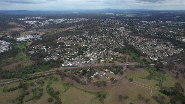 Suburban Homes And Grove Road Reserve Park On The Banks Of Logan River In Queensland, Australia. aerial pullback shot