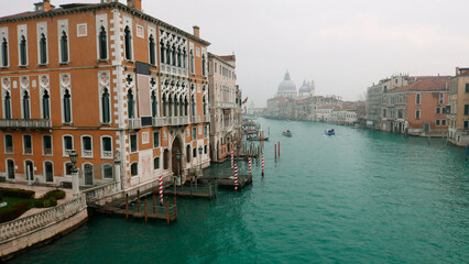 Venice in winter fog. Uncrowded Grand Canal. View towards Basilica di Santa Maria della Salute from Ponte dell'Accademia bridge.