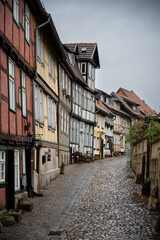 Quedlinburg in Germany, narrow street with historic houses.