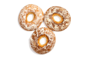 Three bagels with icing on a white background. Gingerbread with a hole.