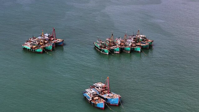 Vietnamese Fishing Boats; Big Trawlers; Squid Fishing Vessels Anchored Offshore In Southeast Asia: Slow Aerial Flyover.
