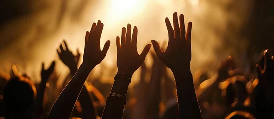 Foto op Plexiglas Christian hands lifted in worship, forming a silhouette. © AkuAku