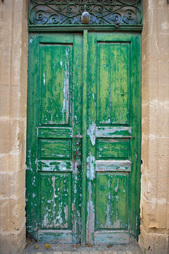 Old historical colorful doors and shutters made of wrought iron and wood. Old historical wooden doors in Cyprus. Doors and shutters of historical stone houses in Nicosia.