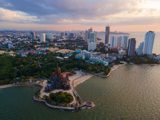Skyline of Pattaya city at sunset with The Sanctuary of Truth wooden temple in Pattaya Thailand by...