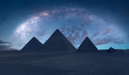 Fotobehang The Milky Way rises over the Pyramids in Giza, Egypt © muratart