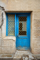 Old historical colorful doors and shutters made of wrought iron and wood. Old historical wooden doors in Cyprus. Doors and shutters of historical stone houses in Nicosia.