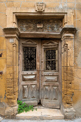 Fototapeta na wymiar Old historical colorful doors and shutters made of wrought iron and wood. Old historical wooden doors in Cyprus. Doors and shutters of historical stone houses in Nicosia.