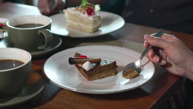 Woman Enjoys Slice of pumpkin Brownie Cream Pie dessert, women hands eating pie dessert
