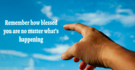 Motivational quote about remembering you blessed you are on sticky note with hand pointing to sky...
