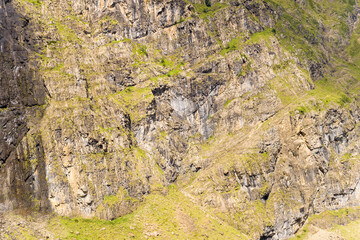 The barren rocky mountains in the middle of the countryside , Europe, France, Occitanie, Hautes-Pyrenees, in summer on a sunny day.