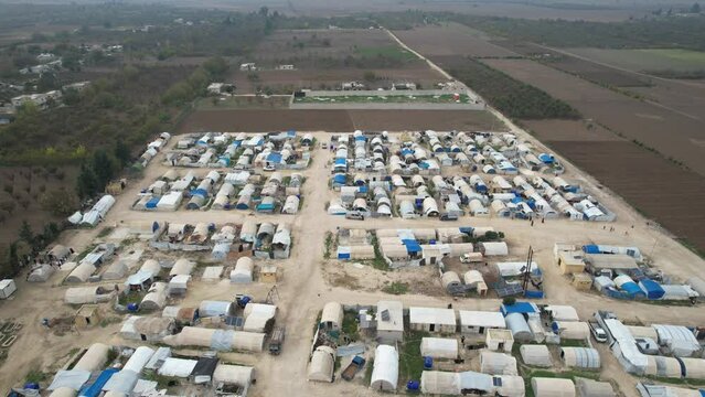 Aerial view of hundreds of tents inhabited by Syrian refugees for years due to the war that destroyed their homes.	