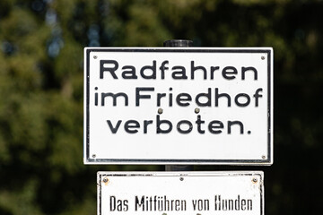 Schild verbietet Radfahren auf einem Friedhof