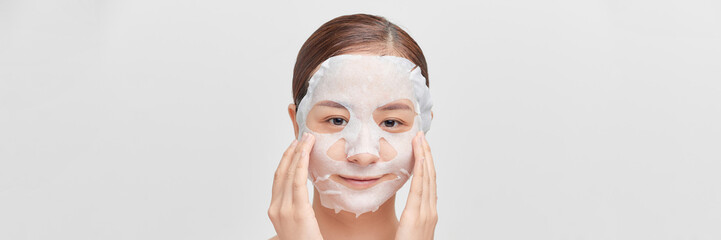 Girl taking care of skin complexion with sheet mask on her face.