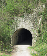cycle path that passes inside a dark tunnel once used by the train
