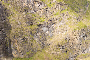 The barren rocky mountains in the middle of the countryside , Europe, France, Occitanie, Hautes-Pyrenees, in summer on a sunny day.