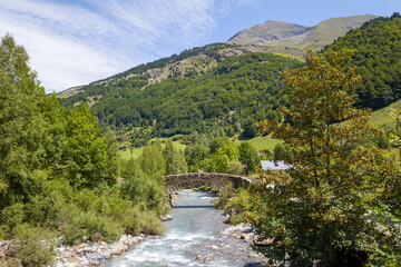 La Riviere de Gavarnie and the Cirque hiking trail , in Europe, France, Occitanie, Hautes-Pyrenees, in summer on a sunny day.