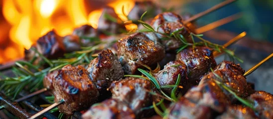 Fotobehang Arrosticini: Italian lamb kebabs with rosemary and spices cooked over a brazier. © AkuAku