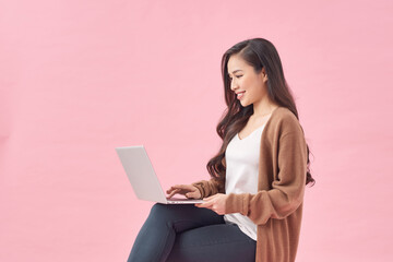 Positive asian lady surfing internet, watching webinar on portable computer