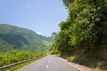 An asphalt road in the middle of the countryside and mountains, in Asia, Vietnam, Tonkin, between...