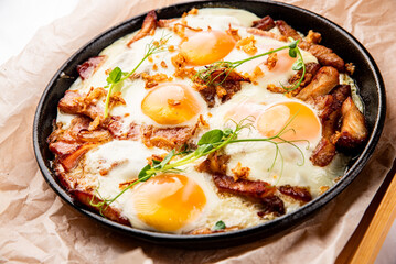 Fried eggs on a frying pan isolated on white background