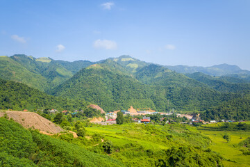 The construction of the hydraulic dam in the green countryside , Asia, Vietnam, Tonkin, between Dien Bien Phu and Lai Chau, in summer on a sunny day.