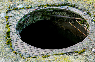Opened, missing sewage cover, conceptual image of human negligence.