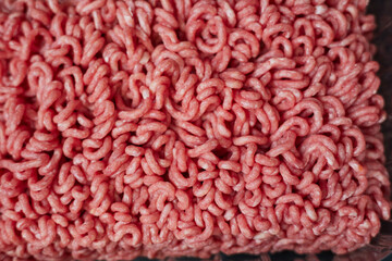 Fresh beef minced meat texture background. Top view of raw beef forcemeat.