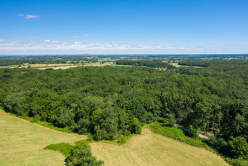 Fototapeta na wymiar The green countryside with its forests and fields in Europe, France, Burgundy, Nievre, towards Nevers, in summer, on a sunny day.