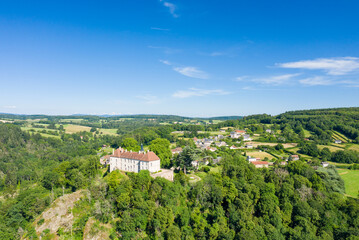 Fototapeta na wymiar The ancient village in the green countryside in Europe, France, Burgundy, Nievre, Larochemillay, towards Chateau Chinon, in summer on a sunny day.