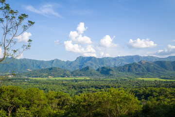Fototapeta premium The green rice fields in the middle of forests and karst mountain peaks, in Asia, Vietnam, Tonkin, between Son La and Dien Bien Phu, in summer, on a sunny day.