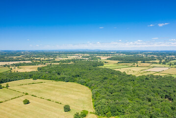The green countryside with its forests and fields in Europe, France, Burgundy, Nievre, towards Nevers, in summer, on a sunny day.