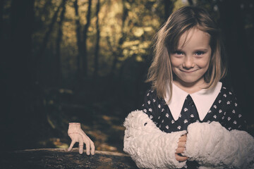 Young girl in halloween style posing in autumn forest