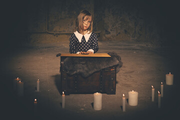 Young girl in halloween style summoning ghosts in empty house