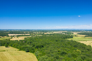 Fototapeta na wymiar The green countryside with its forests and fields in Europe, France, Burgundy, Nievre, towards Nevers, in summer, on a sunny day.