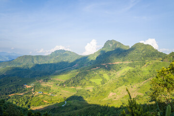The green mountains and wooded valleys, in Asia, Vietnam, Tonkin, between Son La and Dien Bien Phu, in summer, on a sunny day.