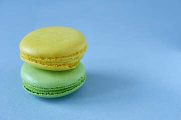 Colorful macaroons on blue background. Macaroon is sweet dessert