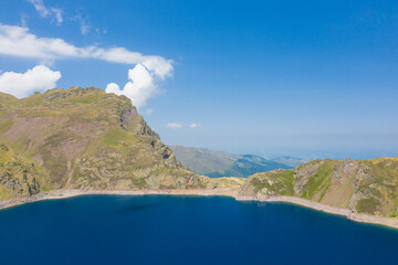 The blue lake in the green countryside in the mountains , Europe, France, Occitanie,...