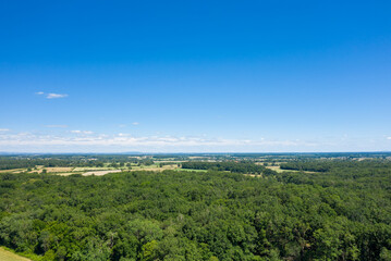 The green countryside with its forests and fields in Europe, France, Burgundy, Nievre, towards Nevers, in summer, on a sunny day.