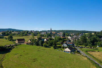 Fototapeta na wymiar A traditional village old seaside resort in the middle of the countryside in Europe, France, Burgundy, Nievre, Saint-Honoré-les-Bains, towards Chateau Chinon, in summer on a sunny day.