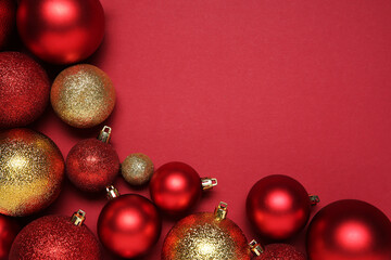 Christmas balls on red background, top view. Space for text