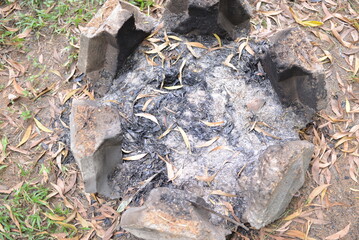 An extinguished fire with many ashes at a picnic campsite