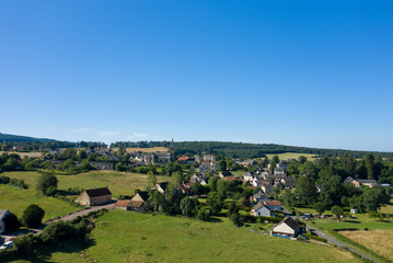 Fototapeta na wymiar A traditional village old seaside resort in the middle of the countryside in Europe, France, Burgundy, Nievre, Saint-Honoré-les-Bains, towards Chateau Chinon, in summer on a sunny day.