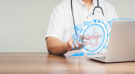 Doctor read a report on an intestine patient checkup on a virtual screen while sitting at a desk