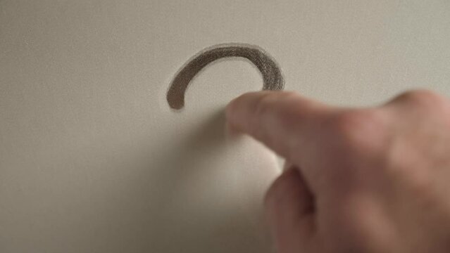 A question mark is painted on the mirror contaminated with dust. Slow motion.