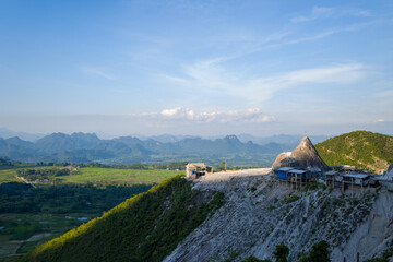 The construction of a building in the mountains above the rice fields, in Asia, in Vietnam, in Tonkin, towards Hanoi, in summer, on a sunny day.