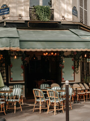 Cozy street cafe on the corner of a house in the center of Paris