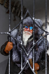 An elderly gray-haired man with a magnificent mustache and beard looks into the distance and...